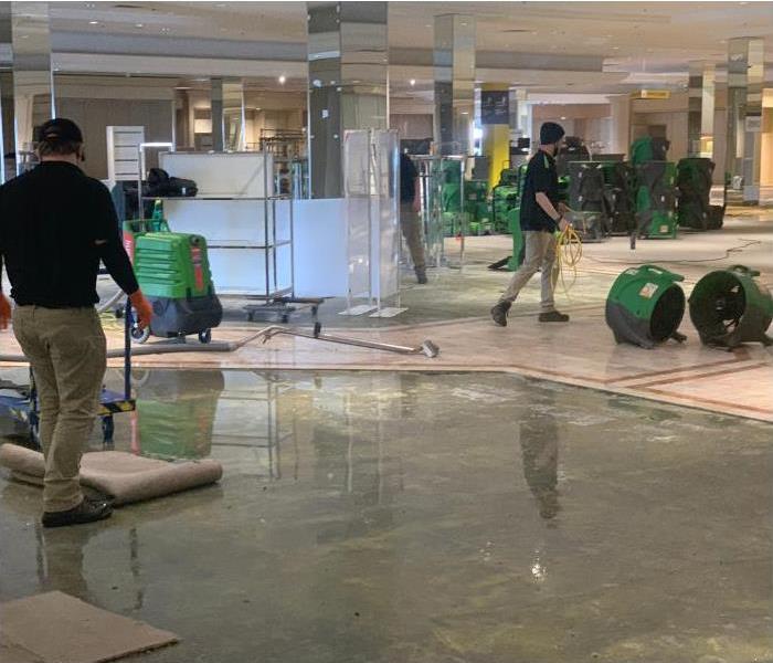 SERVPRO equipment and technicians in a water damaged store